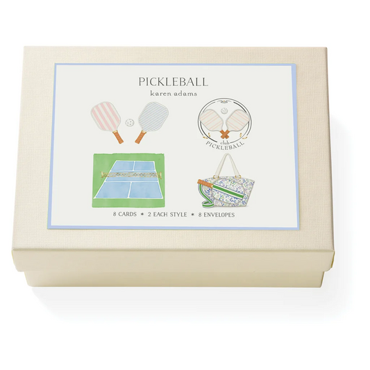 A cream-colored textured gift box for 'Pickleball' by Karen Adams, featuring a white front label with illustrations of pickleball rackets, a court, and a bag.
