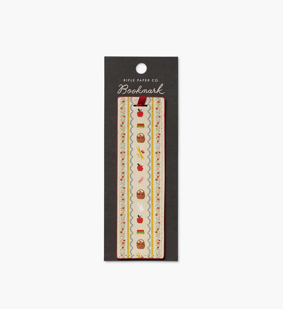 A single bookmark from Rifle Paper Co. in its original black hanging card packaging, featuring a vertical pattern of autumn leaves, acorns, and red apples on a cream background.